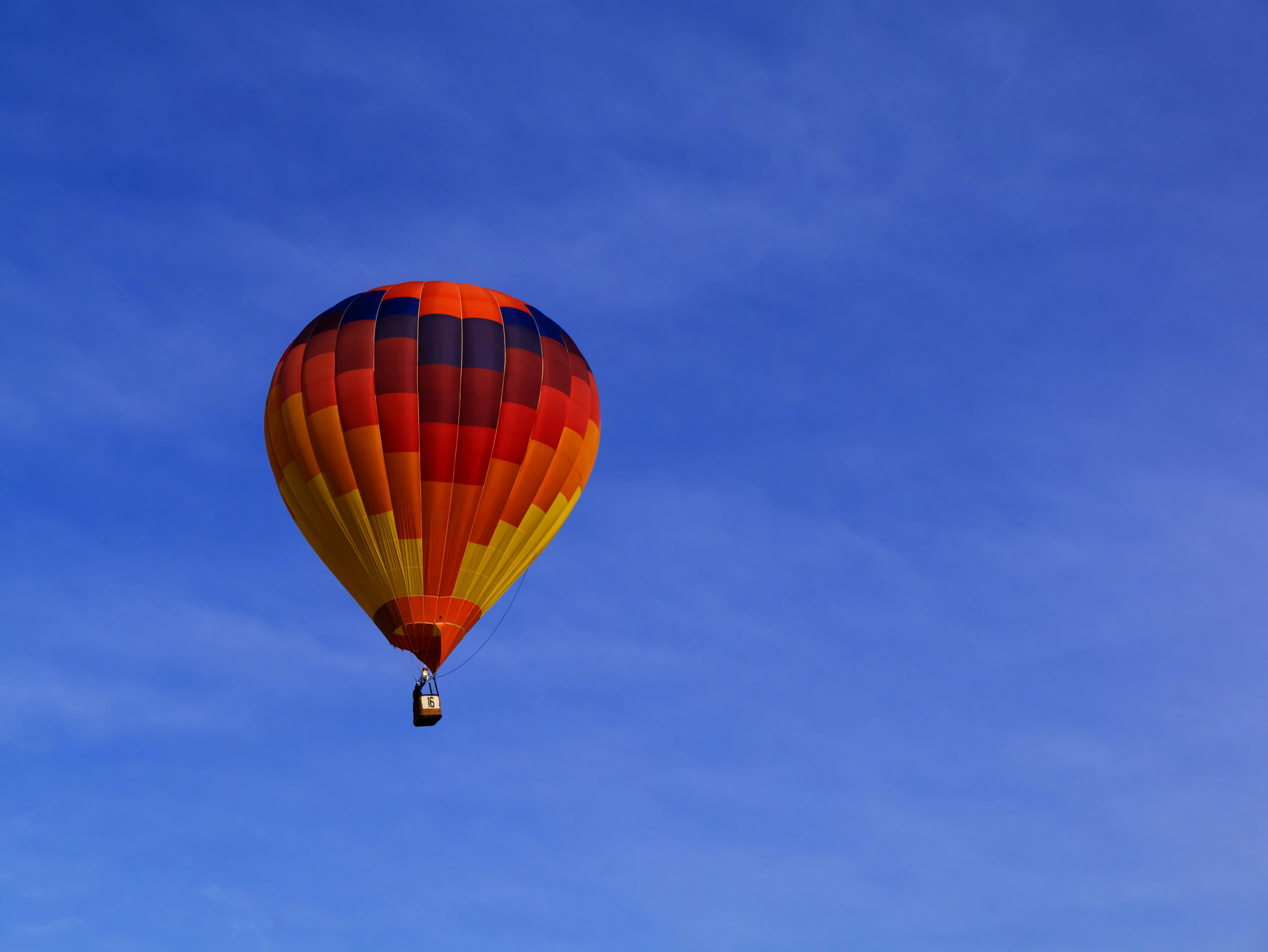 photo of red hot air balloon on sky